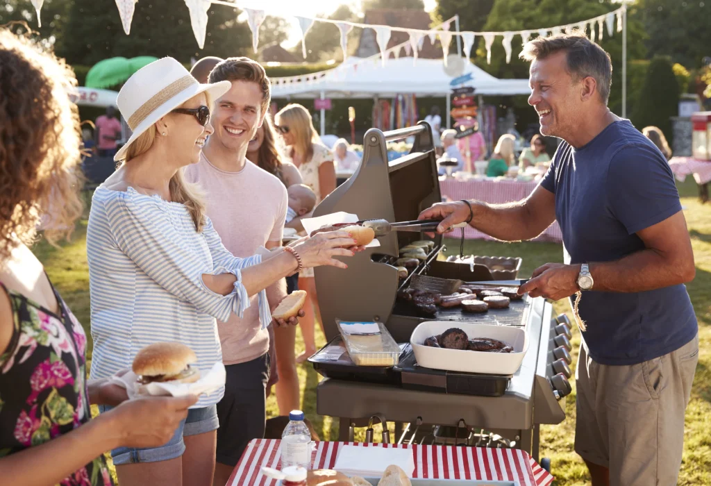 man-serving-on-barbeque-stall-at-summer-garden-fet-2024-10-21-05-35-35-utc